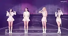 Blackpink wearing white outfits while onstage