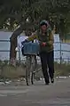 A women pushing a bicycle near Kangso, 2015