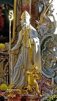 St Blaise with a mitre and crozier, holding crossed candles