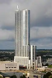 Photograph of a skyscraper that suddenly narrows asymmetrically about half-way to the top
