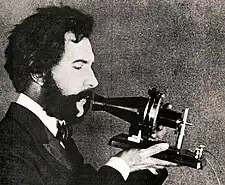 Image 72Actor portraying Alexander Graham Bell in a 1932 silent film. Shows Bell's second telephone transmitter (microphone), invented 1876 and first displayed at the Centennial Exposition, Philadelphia.  (from History of the telephone)