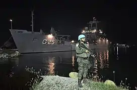 A Brazilian Marine stands guard as NDCC Almirante Saboia docks in Port-au-Prince, 2013.
