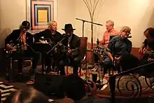 Several musicians seated in a hotel lobby