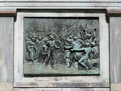 The relief on one side of the plinth.