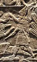 Assyrian warrior holding the head of Elamite King Teumman.