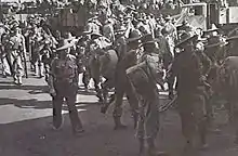 Soldiers at a wharf prepare to embark for overseas