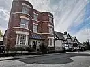 Bow windows of Georgian House with a 1600s timber framed house beside in Wem