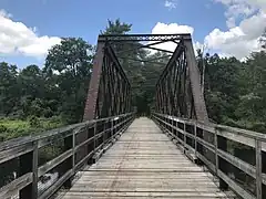 Lattice truss bridge over Ware river entering New Braintree