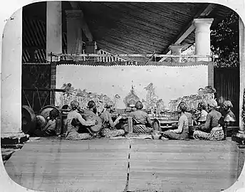 Wayang kulit (shadow puppet show) accompanied by a gamelan ensemble in Java, c. 1870.