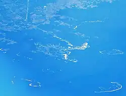 Aerial view of Cedar Key and its outlying islands, illustrating the extremely small size of the city: The fork at State Roads 24 and 347 (the only two access roads) can be seen in the upper left.