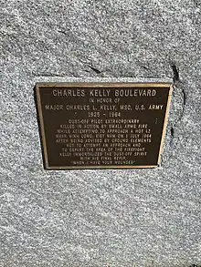 Photo of the Charles Kelly Boulevard commemorative marker at the Fitzsimons Building of the Anschutz Medical Campus.