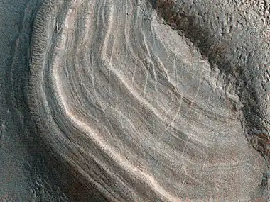 Close view of dipping layers  Each layer was deposited when the climate changed.  These layers only appear in protected areas.