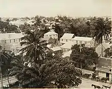 Sepia photograph of a street seen from the rooftops