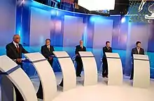Candidates on a debate stage in the TV Bahia studio
