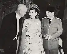 Dwight, Mamie, and Indonesian President Sukarno dressed in formal wear smiling at one another