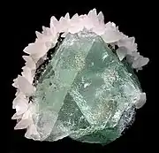 Green fluorite framed by white calcite, Naica Mine, mined in the 1980s. Size: 5.5&nbsp;cm ×&nbsp;5.1&nbsp;cm ×&nbsp;4.4&nbsp;cm (2+1⁄4&nbsp;in ×&nbsp;2&nbsp;in ×&nbsp;1+3⁄4&nbsp;in).