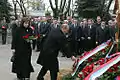 Vladimir Putin and his wife laying flowers on the grave
