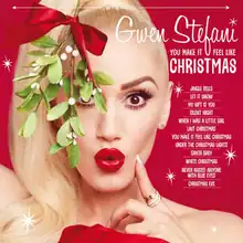 A red background displaying the upper hand of Stefani holding a piece of mistletoe above her head.