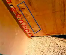 A girder with multiple poorly welded studs.