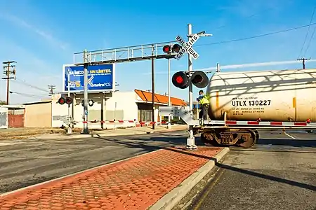 Because there is no caboose, the employee must stand on the last car of this Union Pacific train going in reverse, to make sure the track is clear; something the ETD cannot currently do.