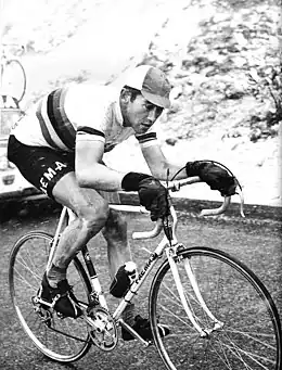 Merckx crouched over his bike, ascending a snowy mountain pass.