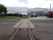 Site of the first timber-built station, opened in 1830 by the Stockton & Darlington Railway, now an industrial estate.