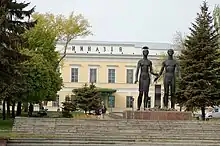 The Gymnasium as seen from the Spartakovsky Pereulok, with the Monument Oath of the Youth in front in 2007.