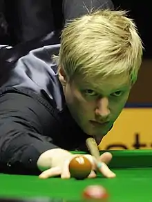 Neil Robertson leaning over a table lining up a shot