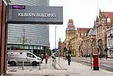 Looking South down the Oxford Road past University place and the Kilburn building sign