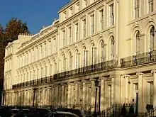 Long, three-story, light-coloured building