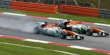 Paul di Resta overtaking Adrian Sutil in identical cars