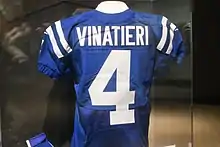 Vinatieri's jersey hanging in a glass case