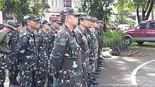 Personnel of the 1st QC TASU await instructions from their officers.