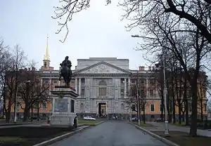 Road leading to a large orange-and-white building