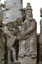 Pontius Pilate turns to wash his hands in a bowl of water held by his servant. He looks across at Jesus being led away by two soldiers