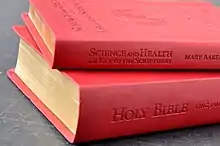 two books, titled bible and Science to Health