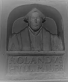 Sir Rowland Hill bust in the school at Market Drayton: the variation in the spelling of his name is notable, as is the style of the monument which may show the approach of his lost funerary monument in London;. The style, which would become popular from the early to mid-17th century, was most commonly used to memorialize divines, academics, and those professions with pretensions of learning. it shows some resonance with the funerary monument of Shakespeare.