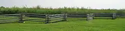 The site of much of the fighting at Island Mound is now covered in prairie foliage, as was about three-quarters of Bates County in the mid 19th Century. A split rail fence, also typical of the period, sets off the prairie from the viewing station.