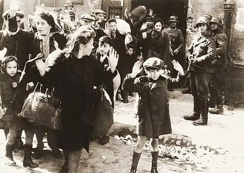Image 6Warsaw Ghetto UprisingPhoto credit: USHMMJews captured by SS and SD troops during the suppression of the Warsaw Ghetto Uprising are forced to leave their shelter and march to the Umschlagplatz for deportation. The SD trooper pictured second from the right, is Josef Blösche, who was identified by Polish authorities using this photograph. Blösche was tried for war crimes in Erfurt, East Germany in 1969, sentenced to death and executed in July of that year.More featured pictures