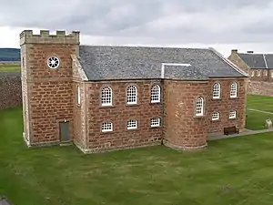 The 18th-century chapel's interior has a two-tiered arcade on three sides supported by Roman Doric columns
