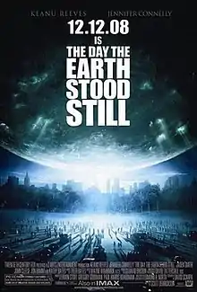 A large crowd of people look up at the sky to see a glowing planet approach them, with the poster's text reading "12.12.08 IS THE DAY THE EARTH STOOD STILL".