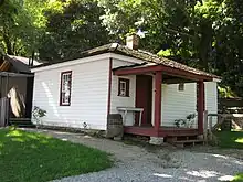 Exterior view of a white wooden building from the 19th century