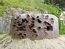 Colour photograph of a badly damaged metal structure