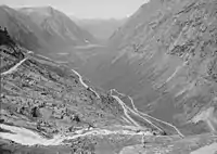 The deep U-shaped Isterdalen [no] valley in Norway ends abruptly giving rise to tall waterfalls. Trollstigen road climbs the steep cliffs of the trough end.