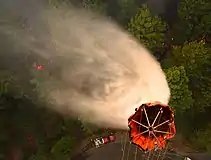 U.S. Airmen with the 129th Rescue Wing, California Air National Guard drop water on the Rim Fire near Yosemite, California, August 26, 2013