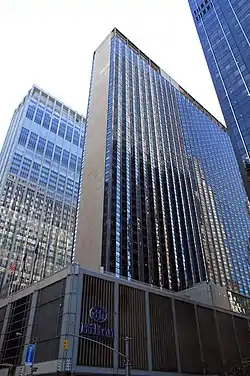A large skyscraper called the New York Hilton Midtown, in daylight in 2013