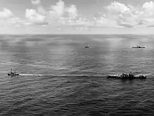 USS&nbsp;Canberra (foreground) and Houston (background) under tow on 18 October
