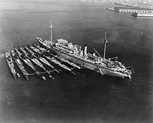 V-boats (left to right) Cachalot, Dolphin, Barracuda, Bass, Bonita, Nautilus, Narwhal, with submarine tender Holland
