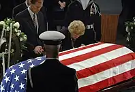 Ford leans over President Ford's coffin during memorial services for him held December 30, 2006 in the United States Capitol rotunda as part of his state funeral