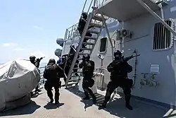 Members of the Brunei Special Forces rush towards the pilot house of USS&nbsp;Howard&nbsp;(DDG-83) during a visit, board, search and seizure exercise, August 2008.